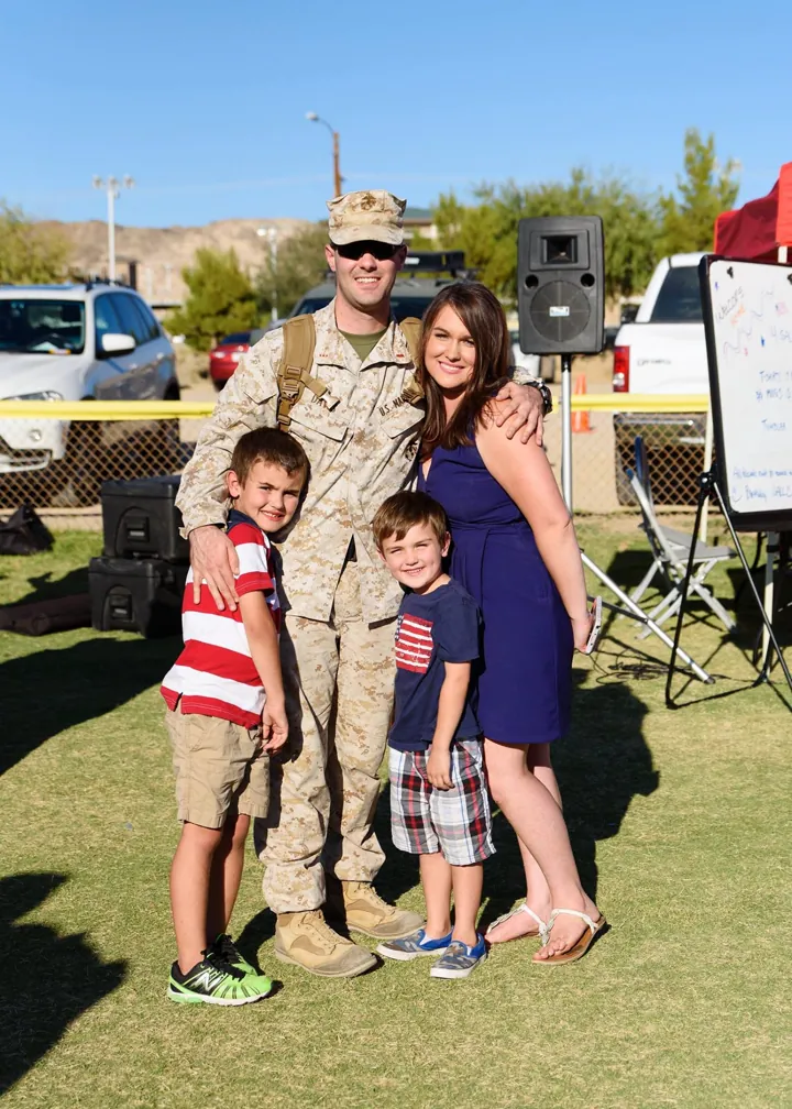 Jerrett in Marine uniform with his wife and two young sons at a homecoming