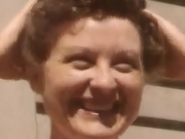 AI-enhanced restoration of the same frame — crisp facial detail
